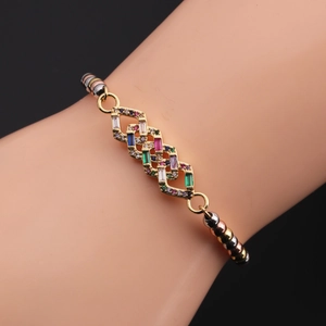 Macro detail of geometric copper bracelet with vibrant colorful zircon stones and tricolor beads