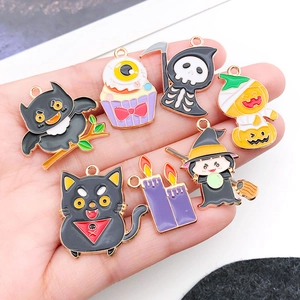 Close-up of Halloween charms like black cats and ghosts with colorful enamel finish
