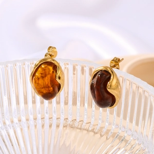 Elegant 18K gold plated round resin stud earrings with amber caramel stones on glass tray