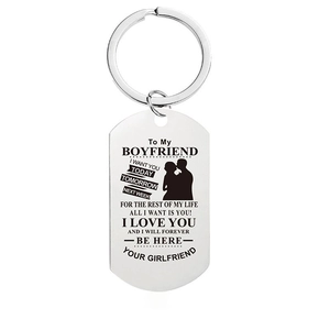Close-up of engraved stainless steel keychain tag with romantic message and couple icon
