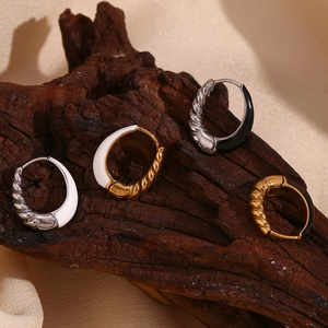 Detailed view of stainless steel pear-shaped earrings with enamel and spiral texture