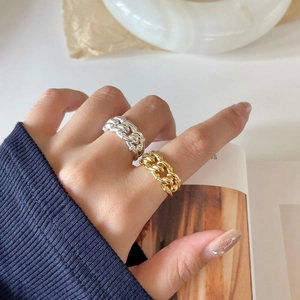 Chunky gold and silver Cuban chain rings for women in minimalist industrial style