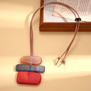 Detail of geometric resin pendant necklace with amber, marble blue and red rectangular links