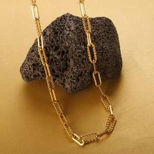 Minimalist gold plated stainless steel twisted chain necklace on volcanic rock