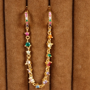 Macro view of 18K gold plated chain earrings with colorful cubic zirconia stones