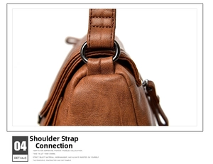 Detail view of brown leather strap connection with dark grey metal ring and stitching