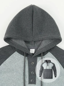 Detail of the metal buttons and drawstring on this two-tone grey casual sports hoodie