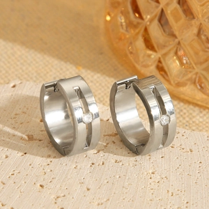 Close-up of polished silver hoop earrings with inset sparkling cubic zirconia stone