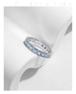 Close-up of S925 silver ring featuring full band of square-cut sparkling blue gemstones