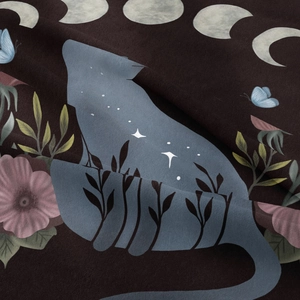 Detail of artistic cat silhouette print with floral patterns on brown tapestry fabric