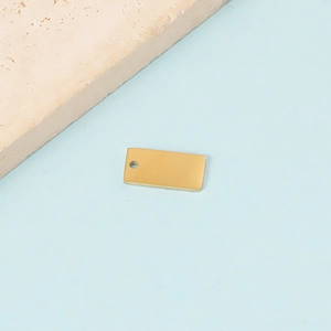 Macro detail of a 5x10mm gold rectangular stainless steel pendant tag for DIY jewelry