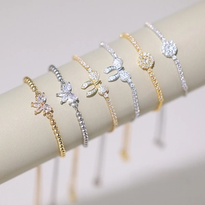 Detail of adjustable bracelets with butterfly and round cubic zirconia on display stands