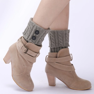 Chic knit leg warmers in sage green with button detail, styled with ankle boots