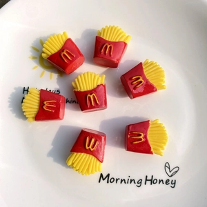 Detailed view of miniature red and yellow resin french fries for DIY craft projects