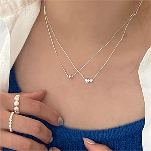 925 silver heart zircon necklace and pearl rings worn by model on blue knitwear