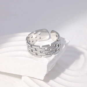 Macro view of geometric hollow pattern on stainless steel open ring with silver finish