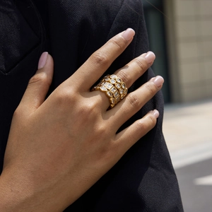 Close-up of a wide 18K gold-plated multi-layer ring with sparkling white zircon stones