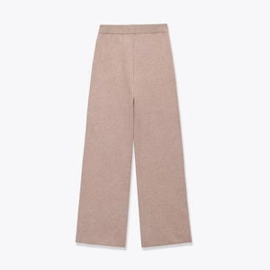 Detail view of wide-leg knit trousers in dusty pink with a ribbed elastic waistband
