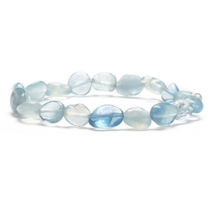 Macro detail of irregular light blue natural stone beads with smooth polished surfaces