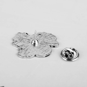 Back view of silver punk poppy brooch with non-slip texture and butterfly clutch pin