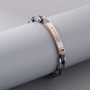 Detail of multi-tone stainless steel curb chain bracelet with brushed metal finish