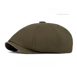 Close-up of military green cotton newsboy cap with six-panel stitching and top button