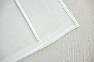 Close-up of high-quality stitching and seam detail on a white backless halter dress