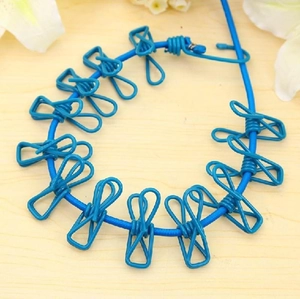 Portable blue retractable clothesline with 12 clips for outdoor travel and drying