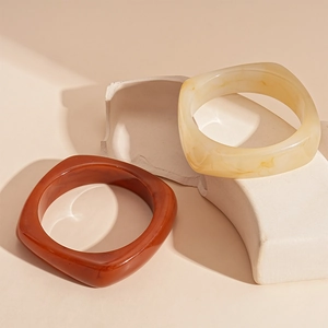 Retro geometric resin bangles in amber tortoiseshell and marble white finish