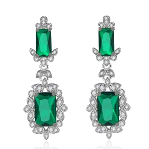 Detailed close-up of emerald-cut green gemstone earrings with sparkling zircon accents