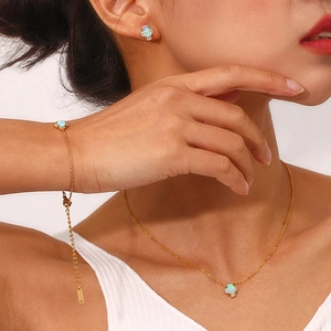 Elegant 18K gold-plated opal jewelry set including necklace, earrings and bracelet on model