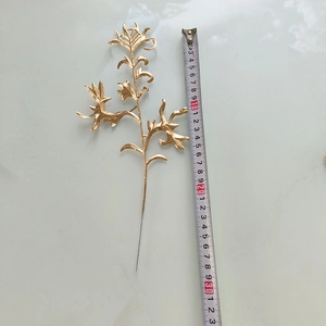 Gros plan sur une branche de feuilles dorées de 33cm avec texture métallique