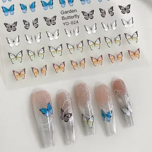 Detail of butterfly nail art stickers with gold foil and gradient blue wing designs