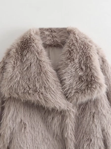 Close-up of fluffy faux fur collar and lapel texture in elegant taupe pink shade