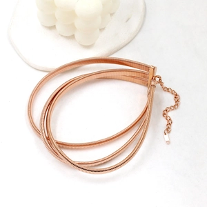 Detailed view of rose gold layered snake chain choker with heart pendant and lobster clasp