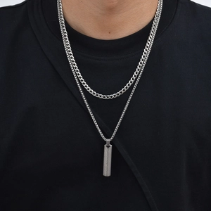 Detail shot of men's double layer stainless steel necklace with textured bar pendant