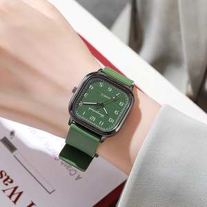 Green square quartz watch with silicone strap and grid pattern dial on a model's wrist