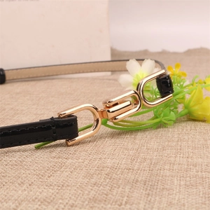 Minimalist black thin leather belt with interlocking gold metal buckle for dresses
