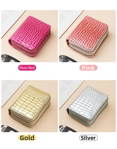 Detail view of double zipper card holders in rose, pink, gold, and silver crocodile texture