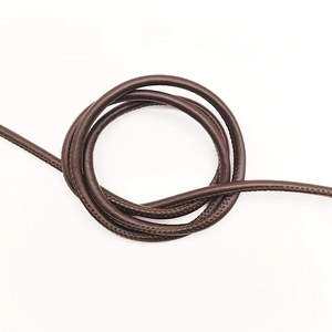 Close-up of 6mm dark brown round leather cord with stitched detail for DIY handbag handles