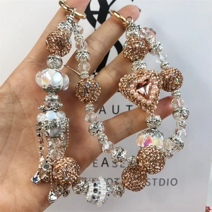 Detail of luxury beaded phone strap with champagne diamond balls and pink heart crystals