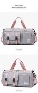 Detail view of grey nylon travel bag with pink straps and functional front pockets