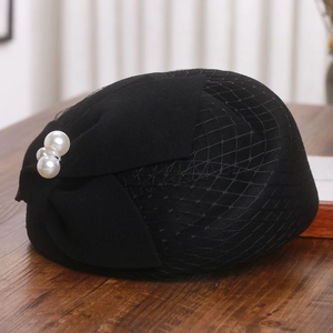 Detail of French wool beret with black mesh veil and three elegant white pearls