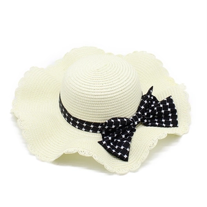 Women's straw sun hat in cream with ruffled edges and checkerboard bow detail