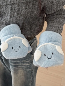 Detail of light blue plush earmuff flip gloves featuring cute smiley face and headphone decor