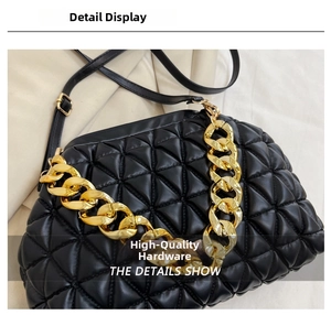 Close-up of black quilted shoulder bag featuring premium gold chain detail and texture