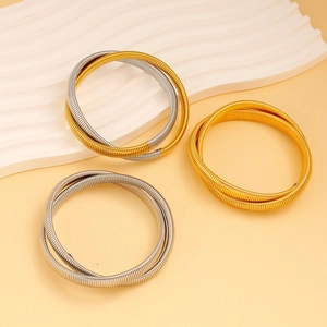 Detail view of gold and silver metallic stretch bracelets with spiral spring texture