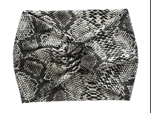 Close-up of snake print pattern and twisted knot detail on wide sports headband