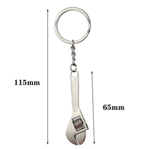 Detail of adjustable metal wrench keychain with 65mm length dimensions on white background
