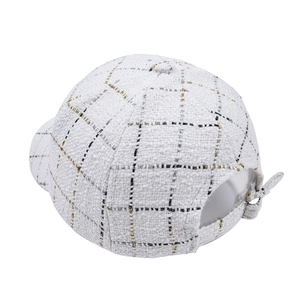Detailed view of white tweed baseball cap with gold metallic threads and adjustable buckle